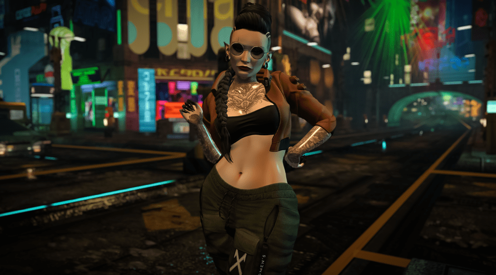 A confident female avatar in Second Life stands in a neon-lit cyberpunk city street at night. She wears sunglasses, a brown cropped jacket, a black top, and green cargo pants. Her arms are tattooed, and her long braid falls over one shoulder. The colorful city lights and signs glow in the background, creating a futuristic, urban vibe.