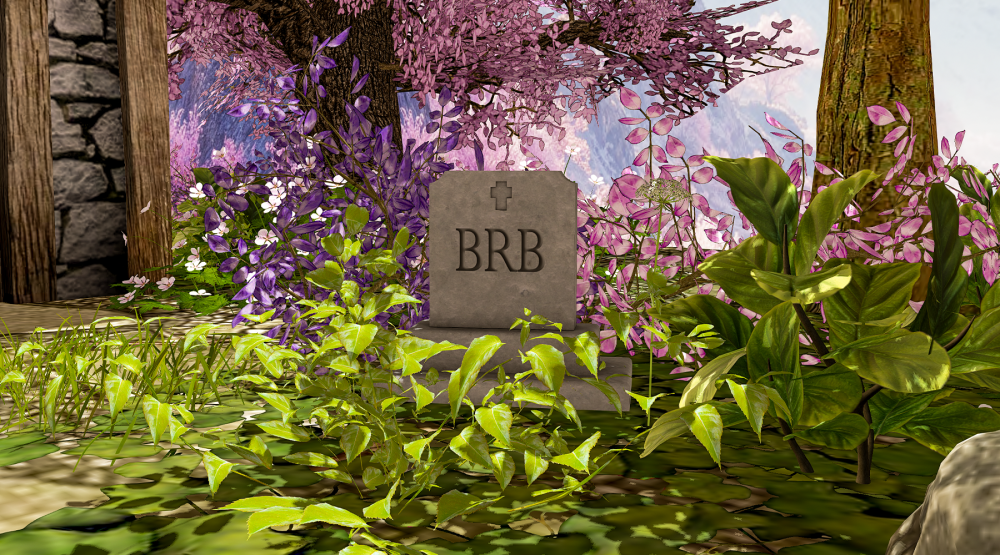 A small stone gravestone engraved with “BRB” sits among lush green plants and blooming pink flowers in a peaceful, whimsical outdoor setting, creating a humorous “AFK memorial” scene in Second Life